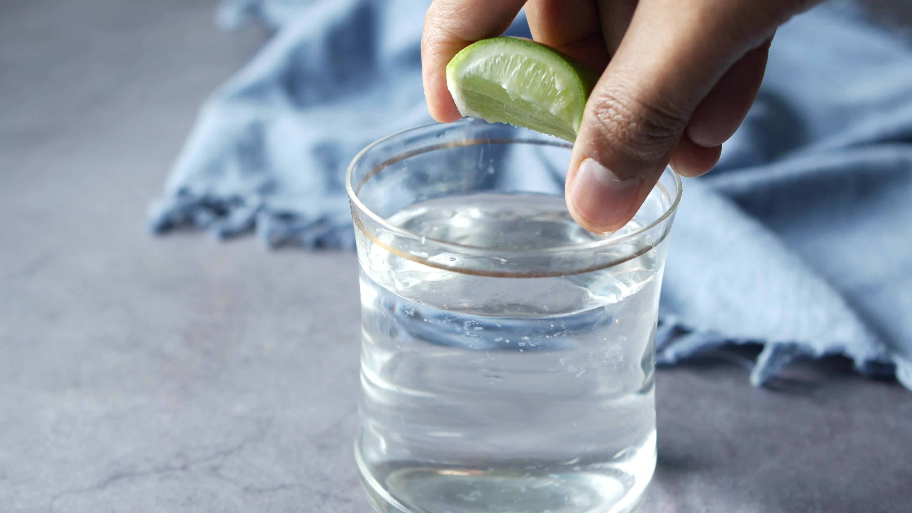 Refreshing lemon water drink on table top view video