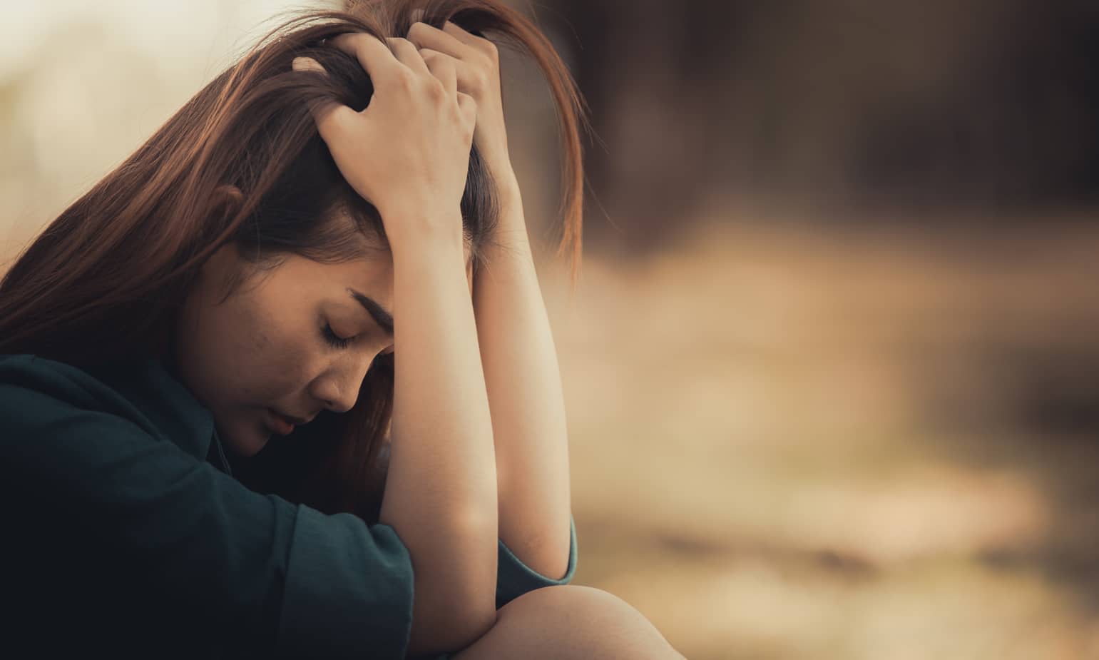 Woman sitting with head in hands