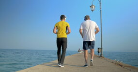 men-exercising-by-walking-backward-along-the-pier-video.jpg