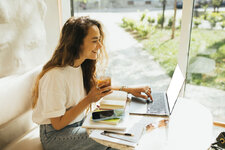 young-woman-freelancer-working-in-a-coffeehouse-u-2023-06-07-17-57-09-utc.jpg